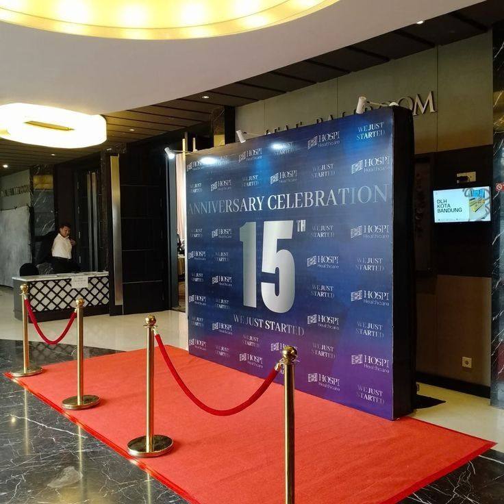 Anniversary celebration photo backdrop with red carpet