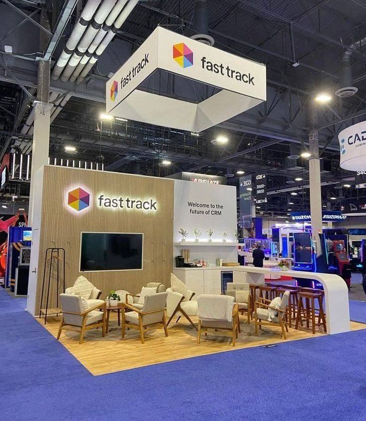 Exhibition booth with lounge seating at a trade show